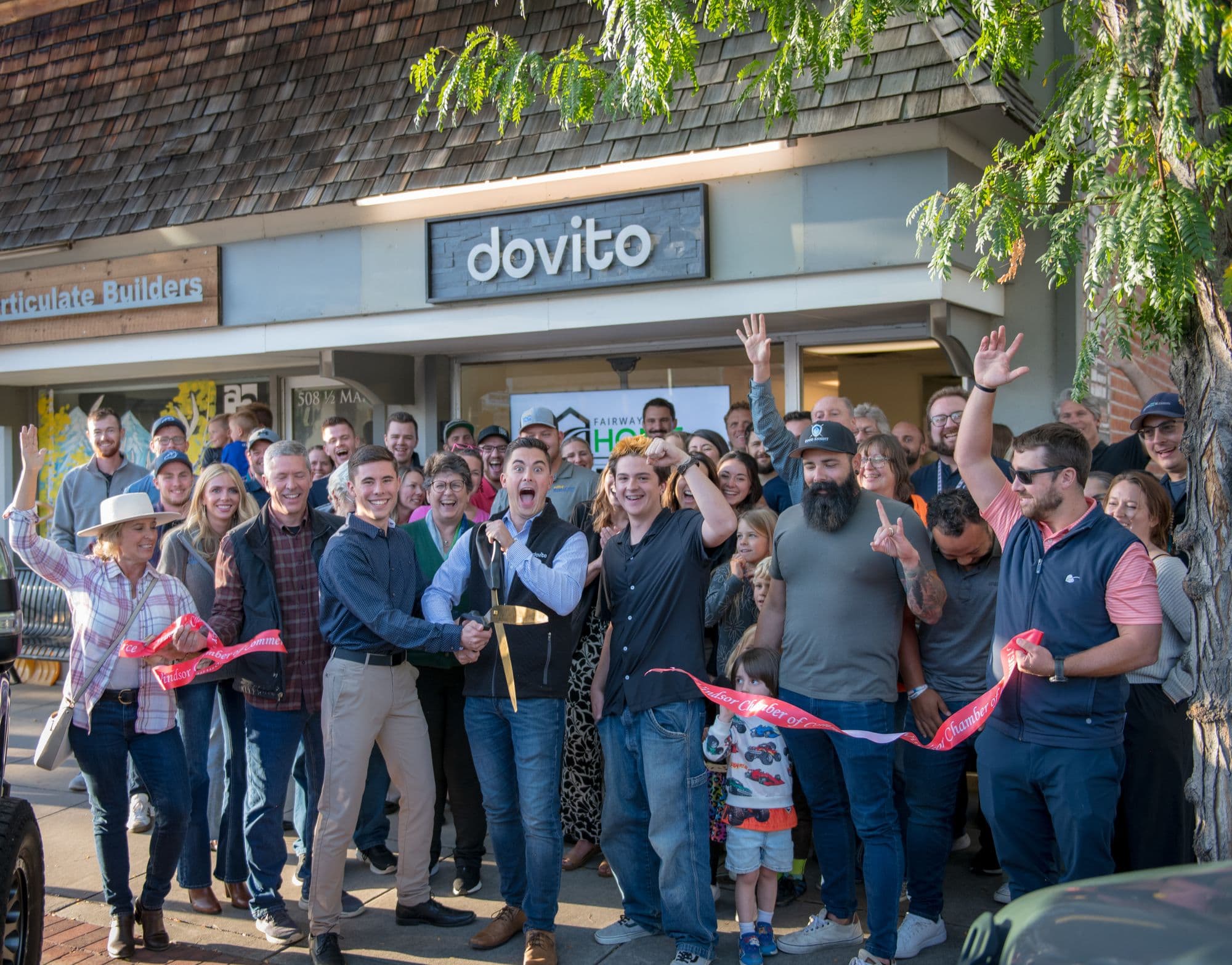 A ribbon cutting in front of the Dovito office