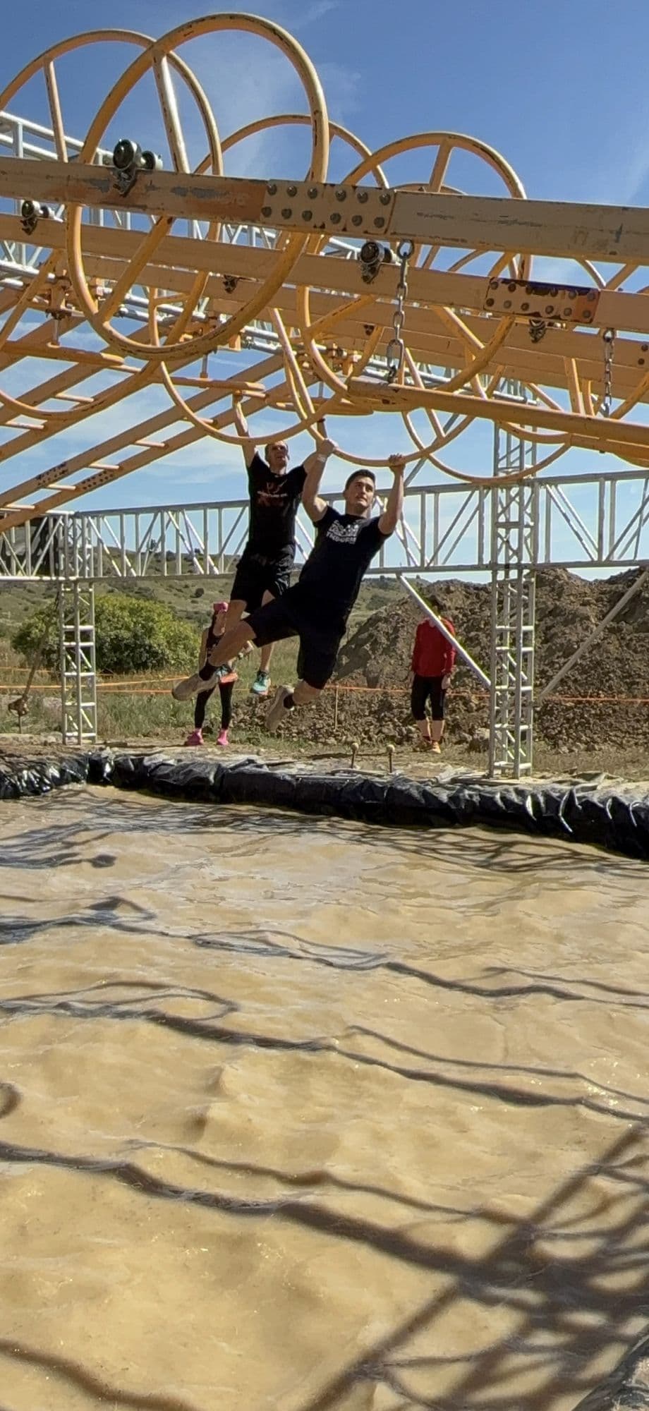 An obstacle course rig against a blue sky